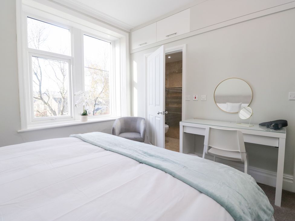A bedroom with a bed, desk, chair, and window at Rocklands in Shap