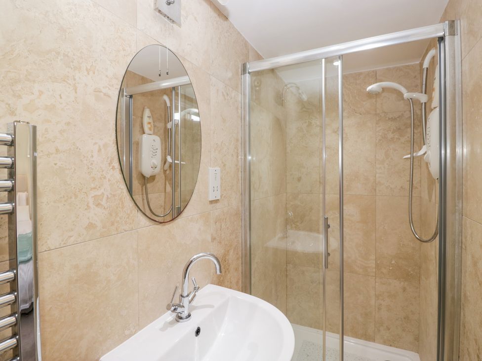 A bathroom with a shower and sink at Rocklands in Shap