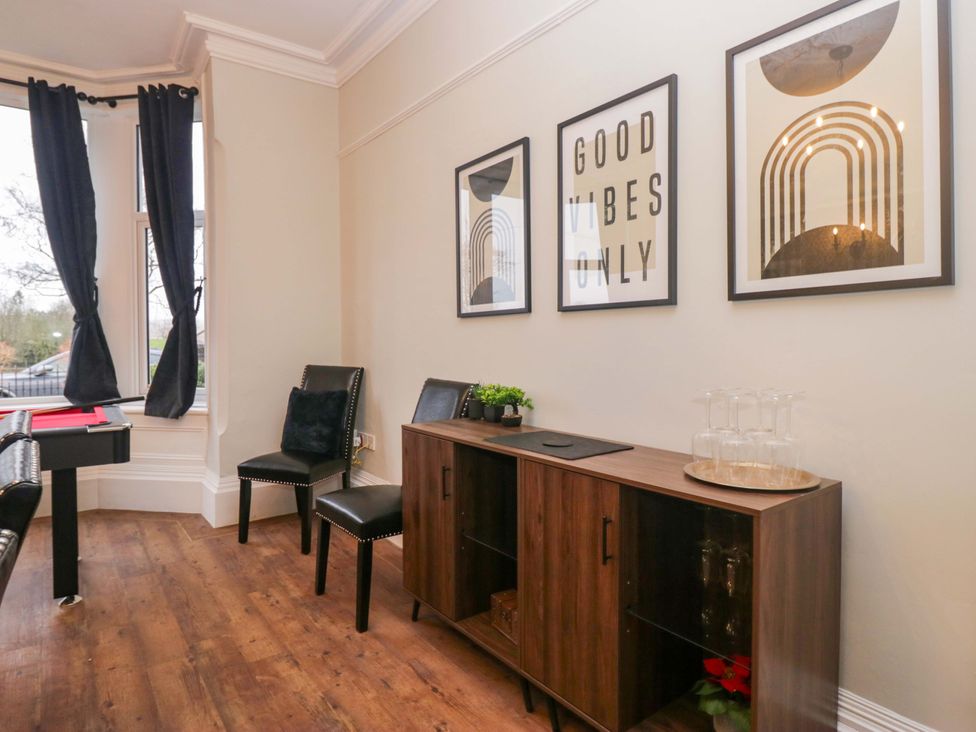 A living room with chairs and cabinet at Rocklands in Shap