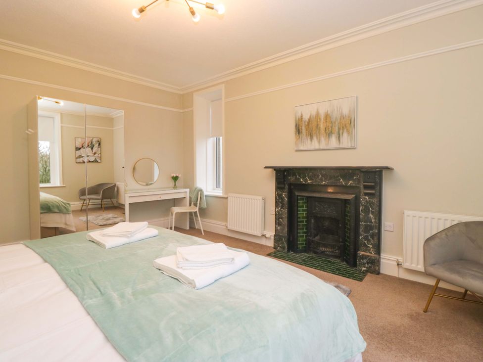 A bedroom with a bed and dressing table at Rocklands in Shap