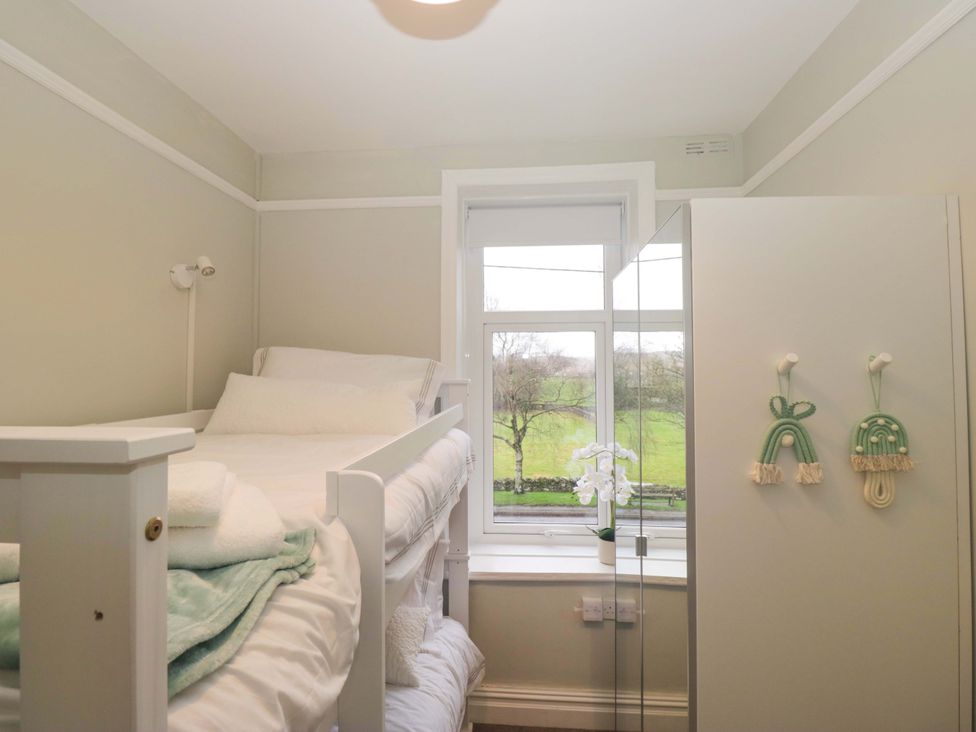 A bedroom with a bed and window at Rocklands in Shap