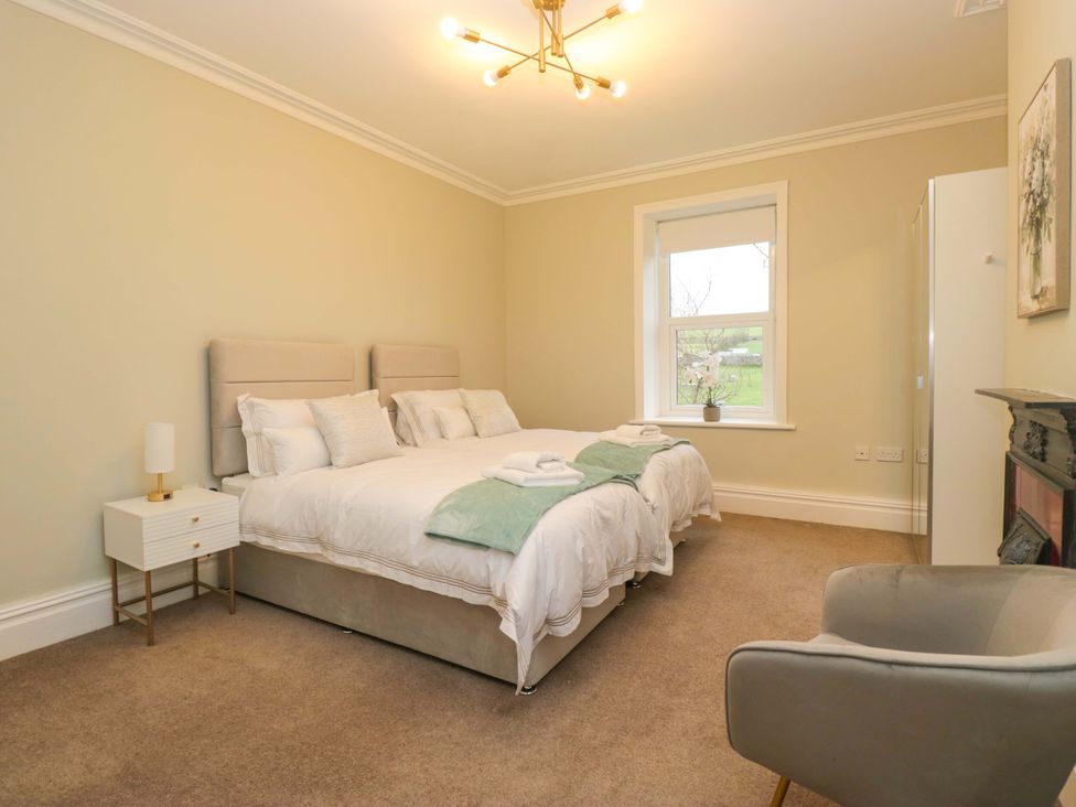 A bedroom with a bed and nightstand at Rocklands in Shap