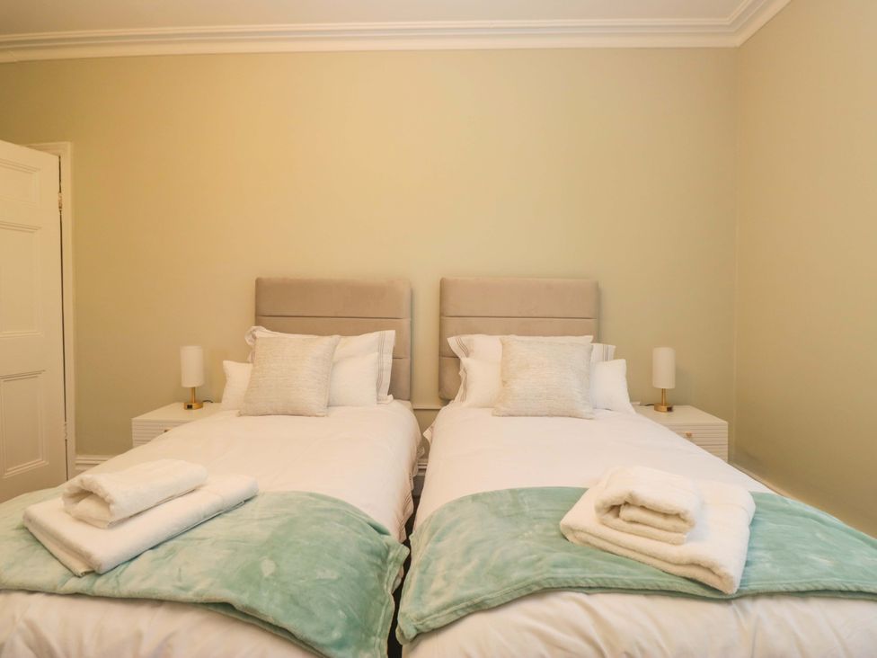 A bedroom with two beds and towels at Rocklands in Shap