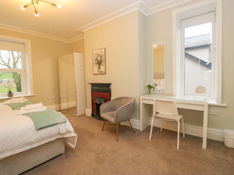 A bedroom with a bed and desk at Rocklands in Shap