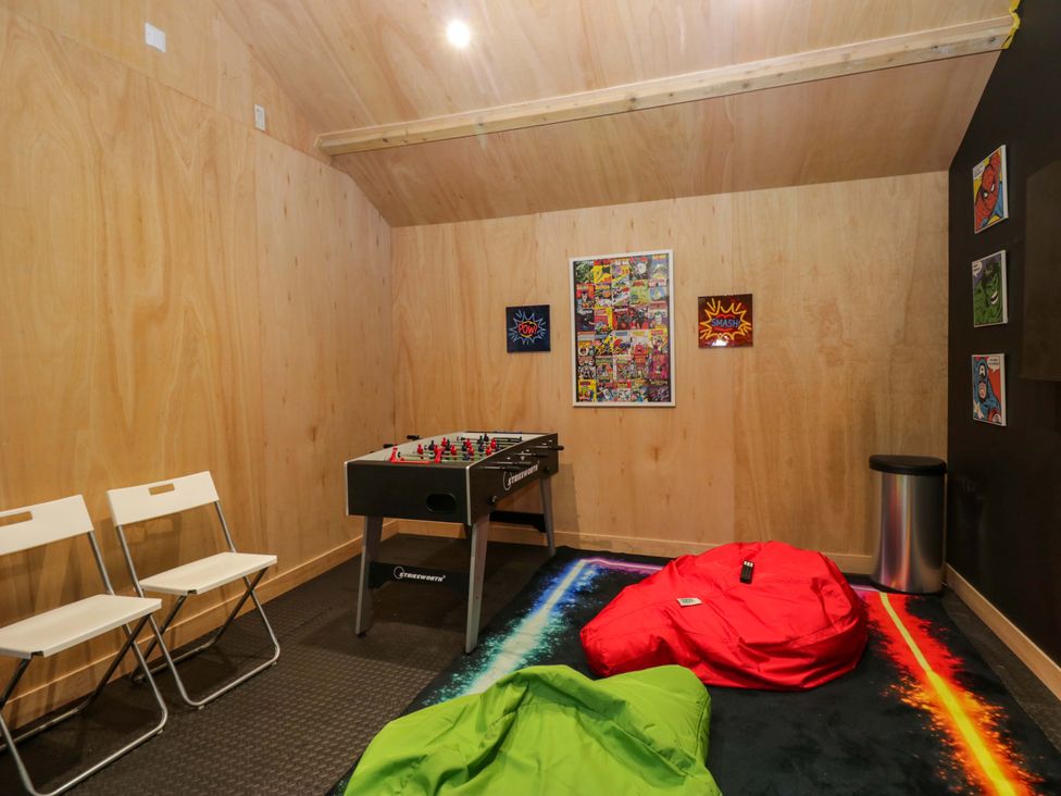 A game room with a foosball table and bean bags at Rocklands in Shap