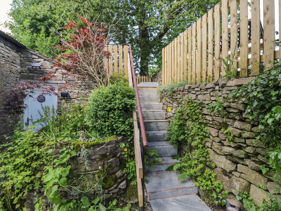 Stairs leading up to a wooden fence and garden at Rocklands in Shap