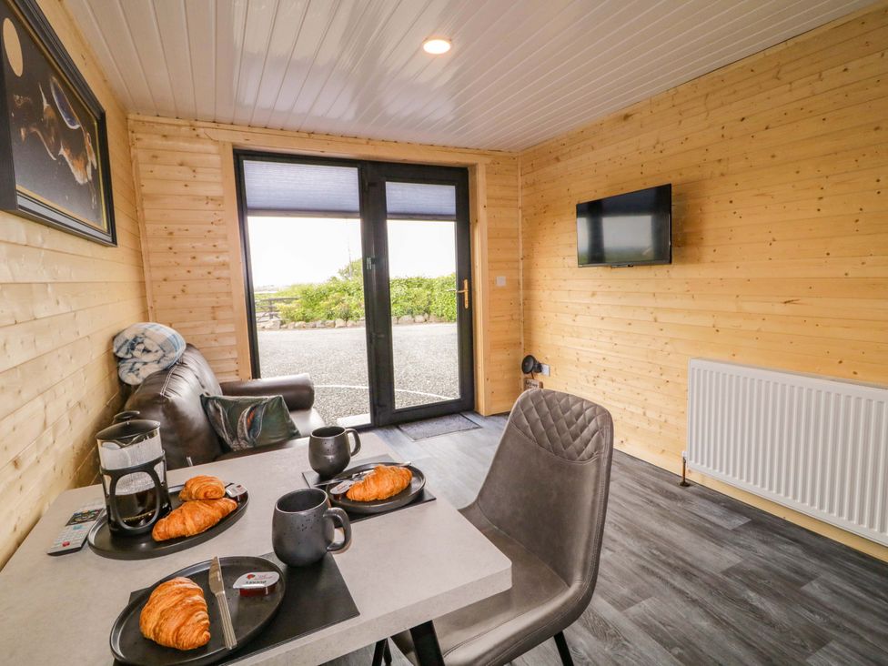 A dining room with a table and coffee on the table at Alken The Hare in Bushmills