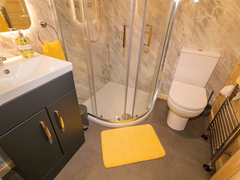 A bathroom with a shower, toilet, and sink at Alken The Hare, Bushmills