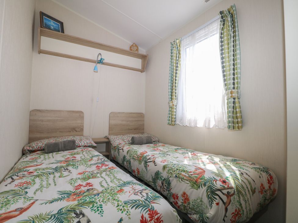 A bedroom with two beds and a window at Tower View Number 34 in Pevensey