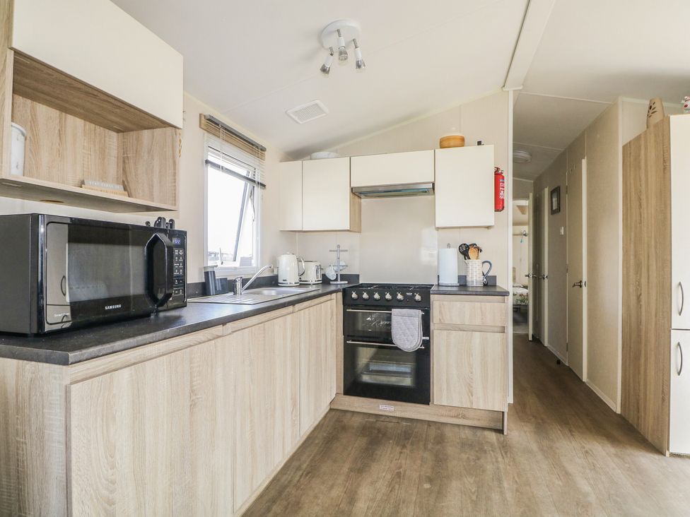 A kitchen with a countertop and appliances at Tower View Number 34 Pevensey Bay