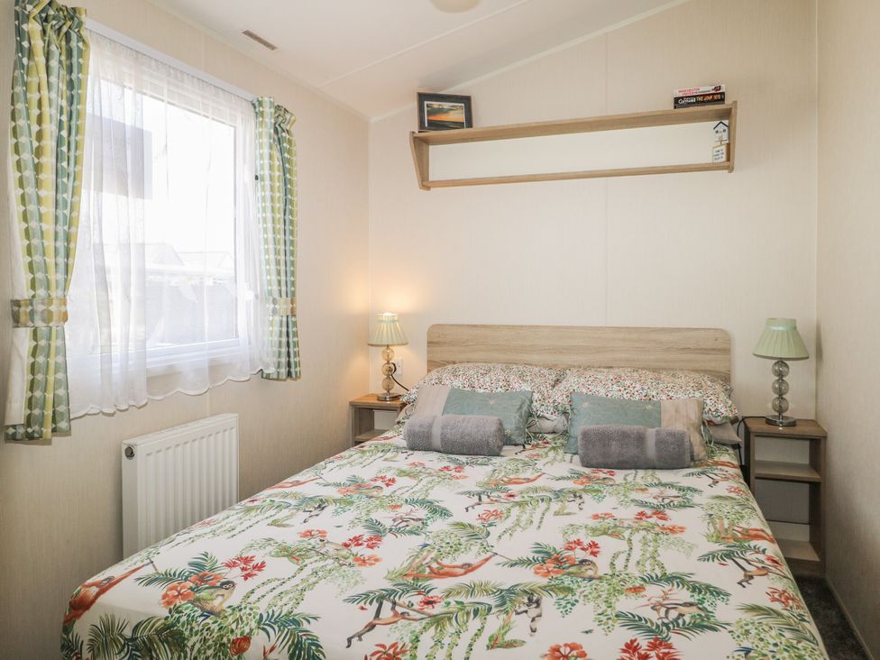 A bedroom with a bed and bedside table at Tower View Number 34 Pevensey Bay