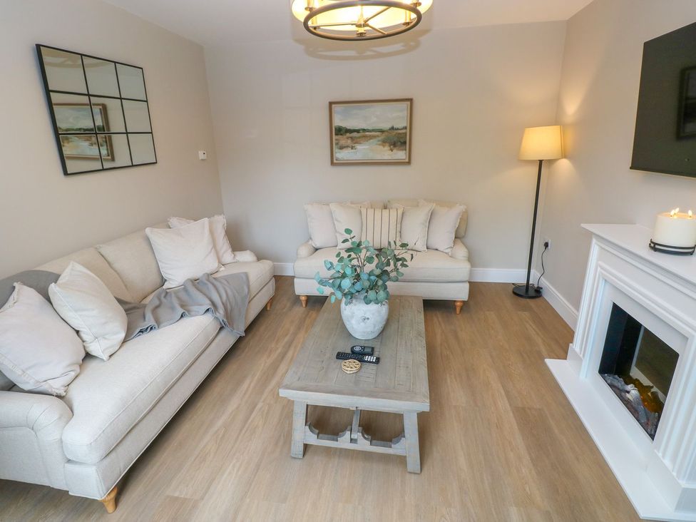 A living room with sofas and a coffee table at Hafan Y Gof in Newcastle Emlyn