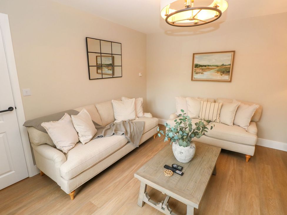 A living room with sofas and a coffee table at Hafan Y Gof in Newcastle Emlyn