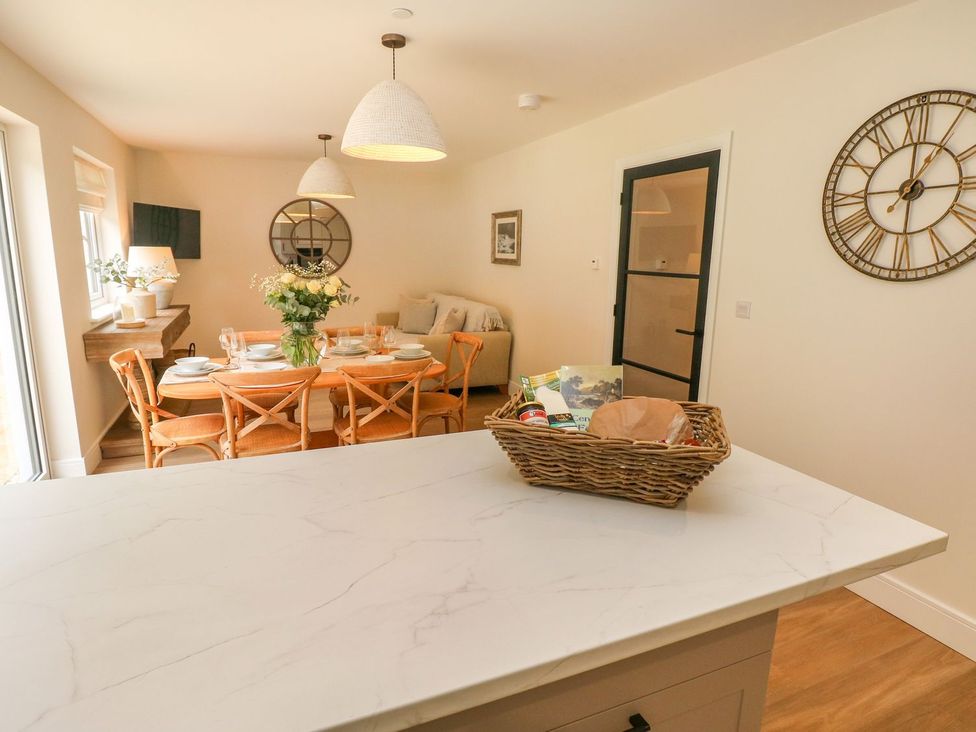A dining room with a table set for meals at Hafan Y Gof Newcastle Emlyn