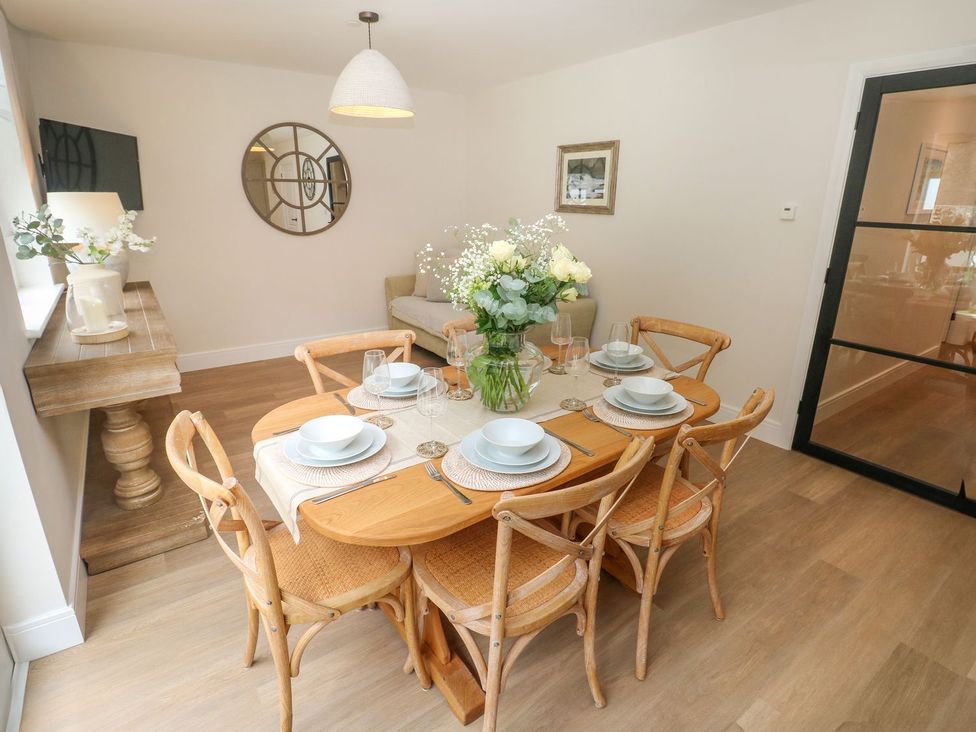 A dining room with a table set for dinner at Hafan Y Gof Newcastle Emlyn