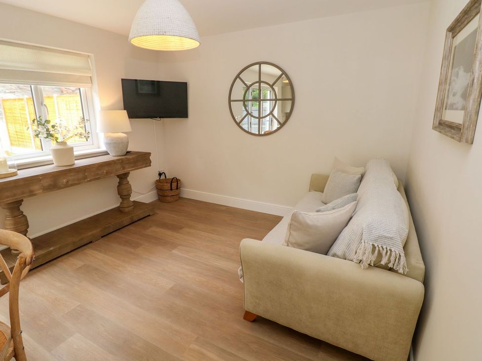 A sitting room with a sofa and a table at Hafan Y Gof in Newcastle Emlyn