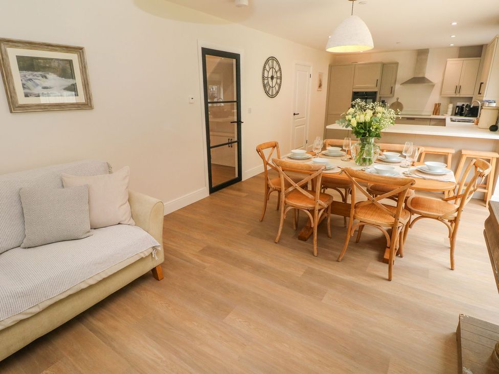 A dining room with a table set for dinner at Hafan Y Gof Newcastle Emlyn