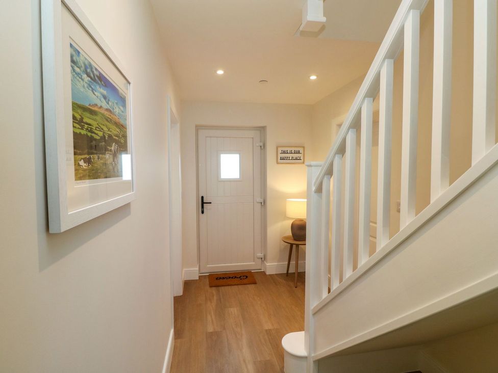 A hallway with a door and lamp at Hafan Y Gof in Newcastle Emlyn