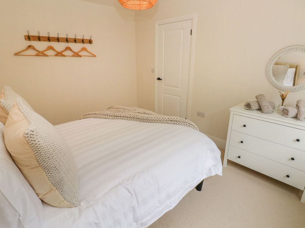 A bedroom with bed and drawers at Hafan Y Gof in Newcastle Emlyn