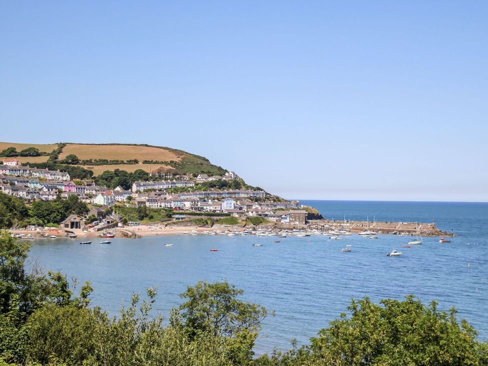 A beach view with boats and houses at Hafan Y Gof Newcastle Emlyn
