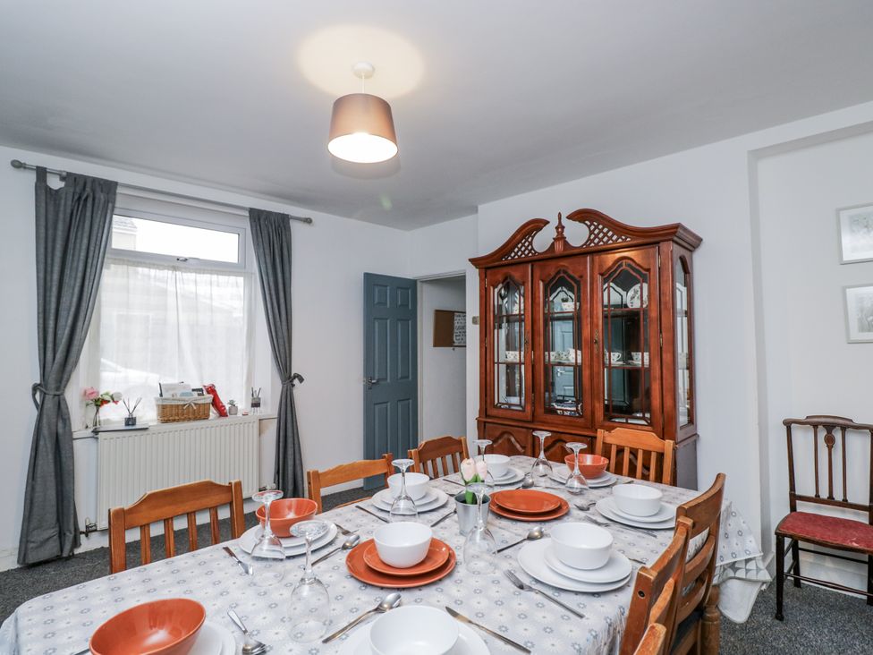 A dining room with a table set for meals at Maindy Lodge
