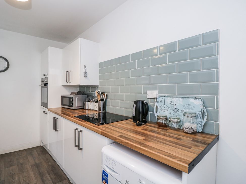 A kitchen with cooking appliances and utensils at Maindy Lodge