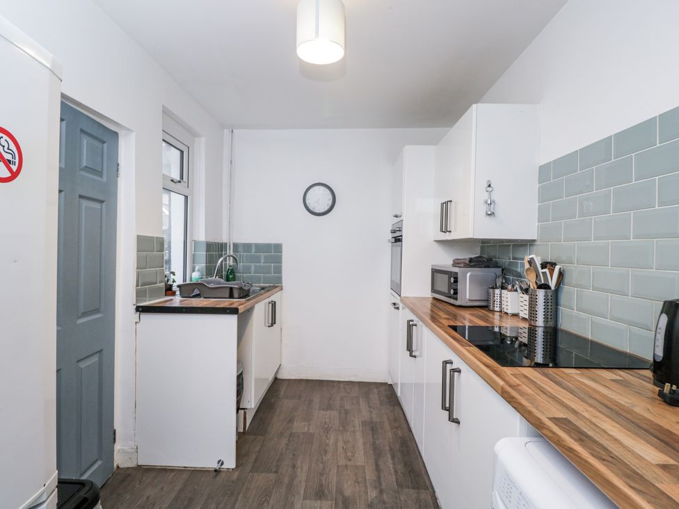 A kitchen with a sink and microwave at Maindy Lodge