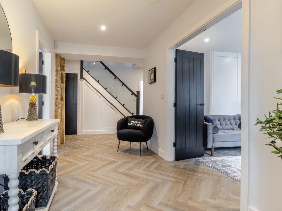 A hallway with a console table and chair at The Old Butchers Arms in Sheffield
