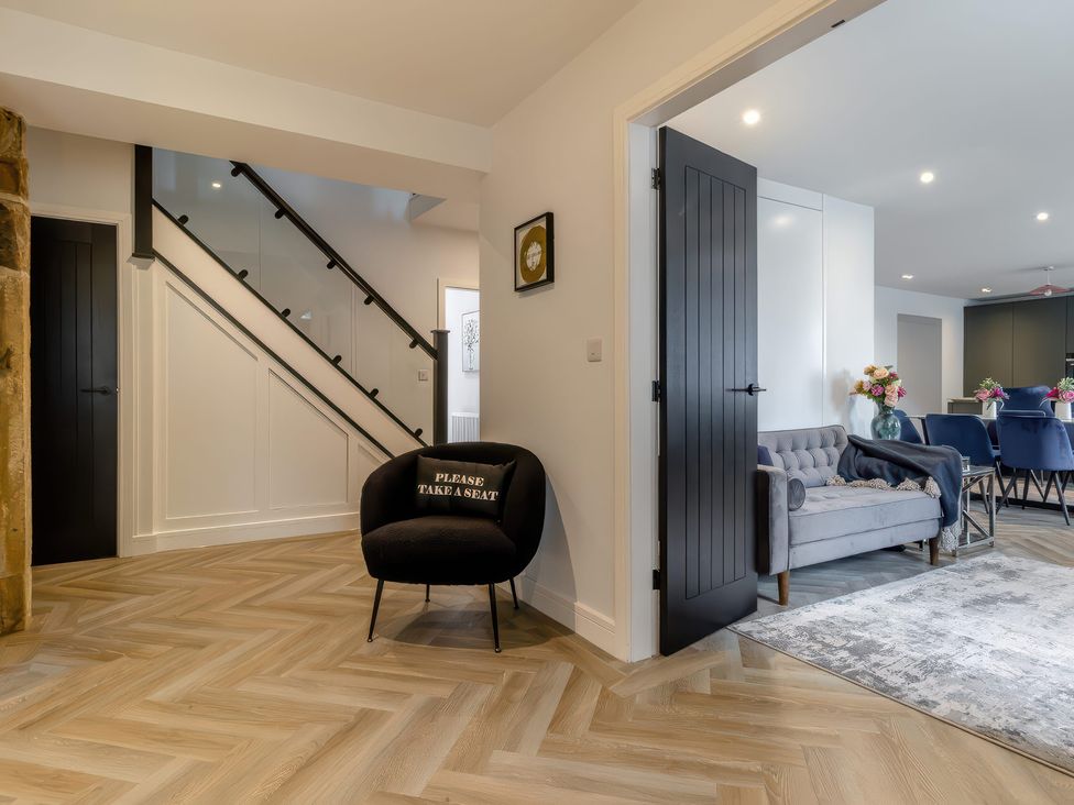 A hallway with a staircase and seating area at The Old Butchers Arms in Sheffield