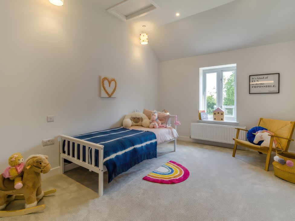 A bedroom with a bed and stuffed animals at The Old Butchers Arms in Sheffield