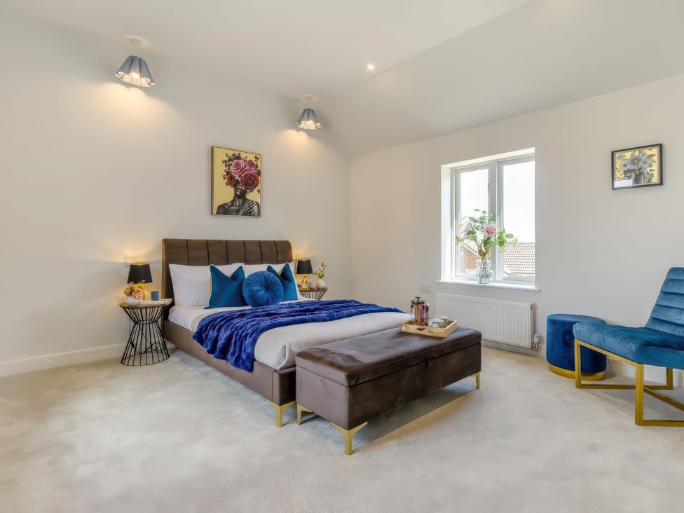 A bedroom with a bed and chair at The Old Butchers Arms Sheffield