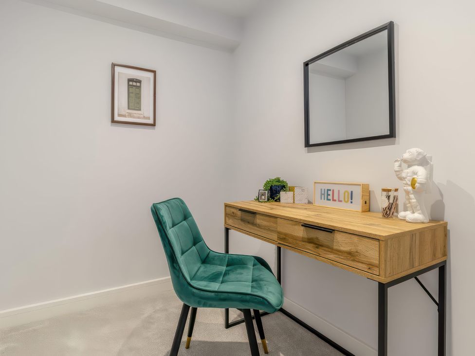 An office with a desk, chair, and mirror at The Old Butchers Arms in Sheffield