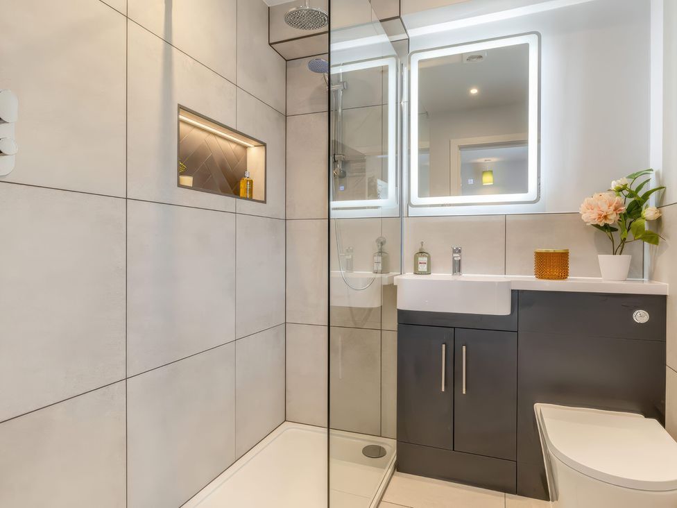 A bathroom with a shower, toilet, and vanity at The Old Butchers Arms in Sheffield