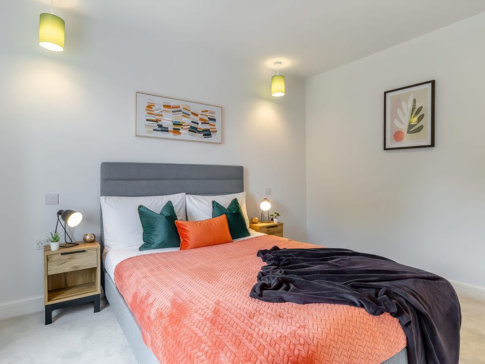 A bedroom with a bed and artwork at The Old Butchers Arms in Sheffield