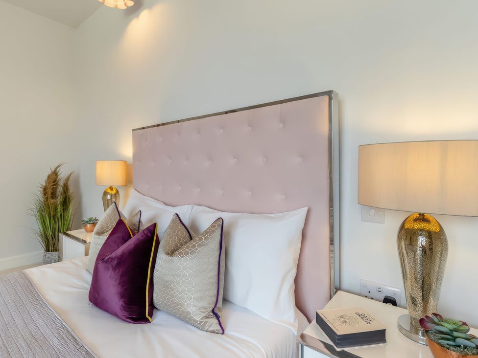 A bedroom with a bed and lamps at The Old Butchers Arms in Sheffield