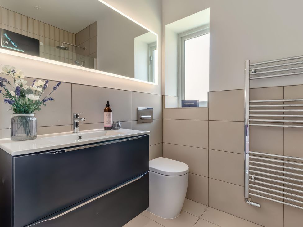 A bathroom with a sink, toilet, and towel rail at The Old Butchers Arms in Sheffield