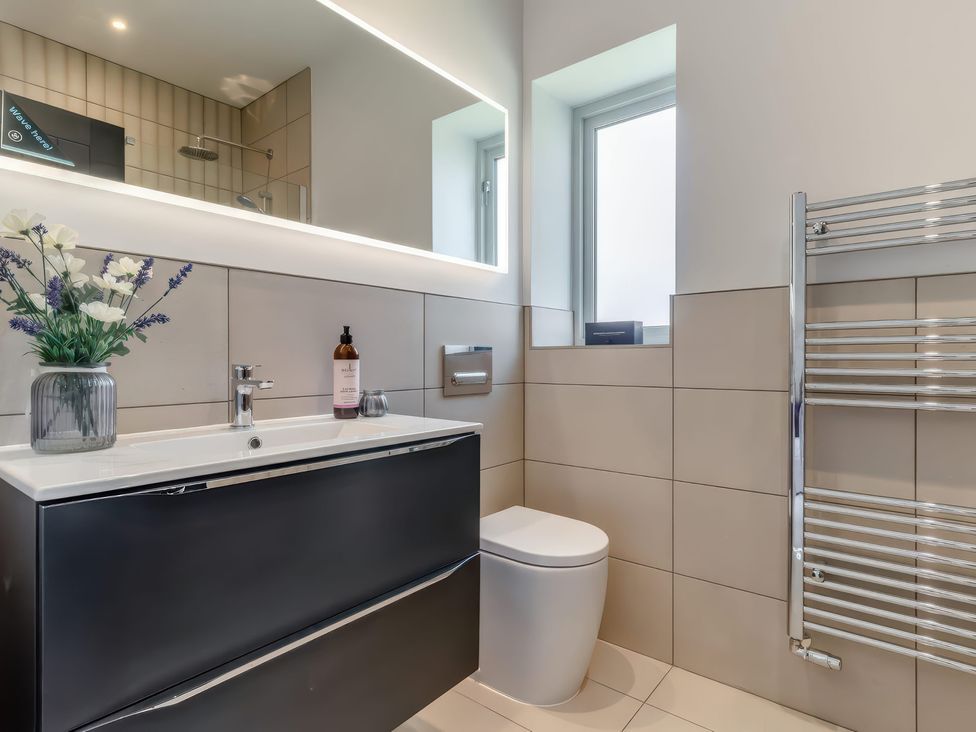A bathroom with a sink, toilet, and towel rail at The Old Butchers Arms in Sheffield