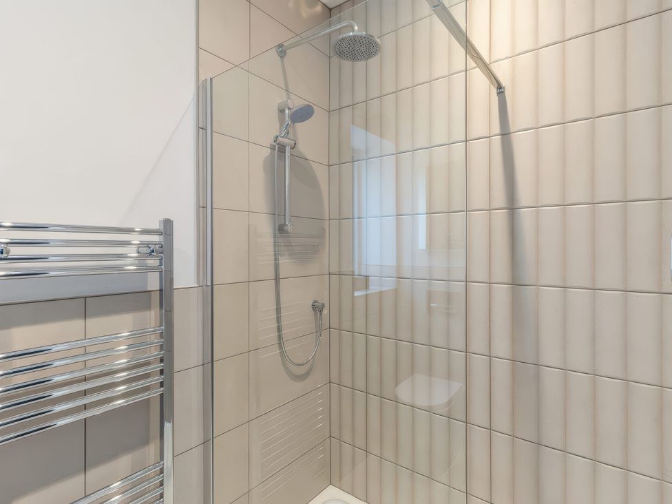 A shower area with tiled wall and towel rail at The Old Butchers Arms Sheffield