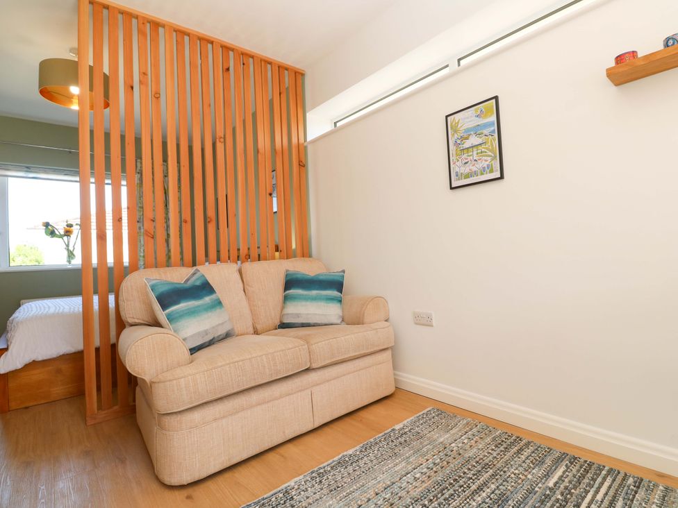 A living room with a sofa and wall art at Carn Brea in Redruth