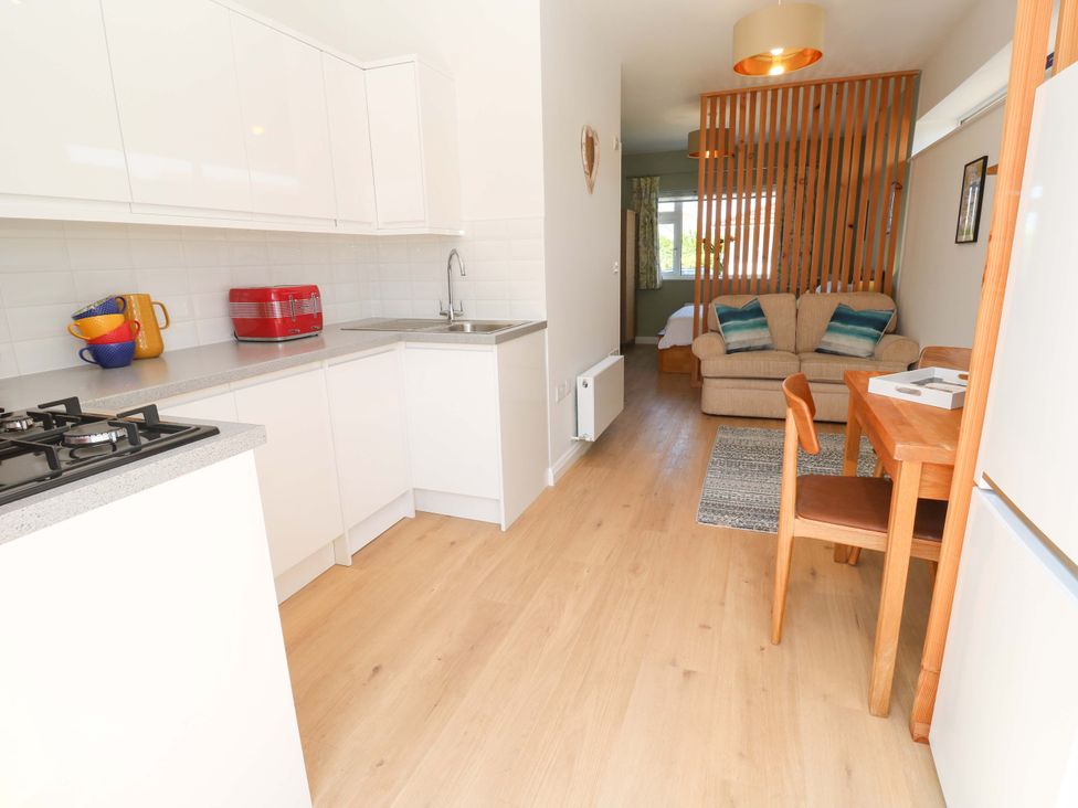 A kitchen with a dining area and sofa at Carn Brea in Redruth