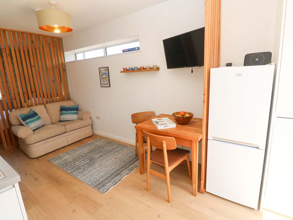 A dining area with a table and chairs at Carn Brea in Redruth