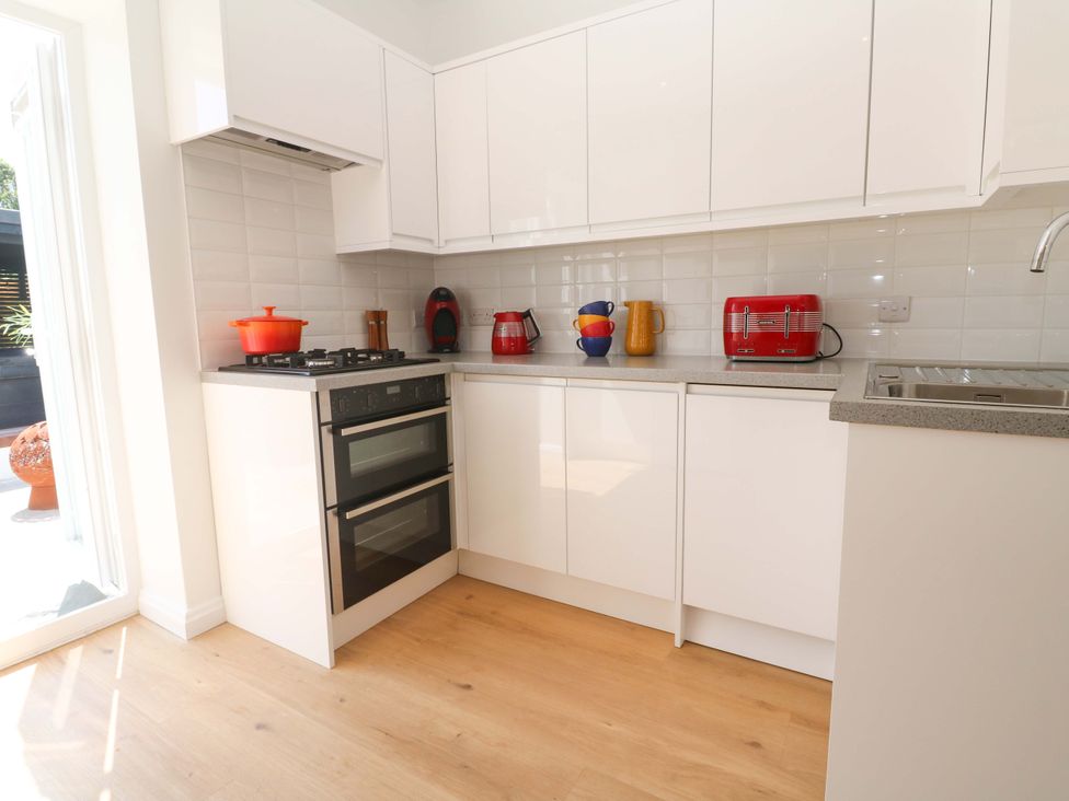 A kitchen with oven, stove, sink, and various kitchen appliances at Carn Brea Redruth