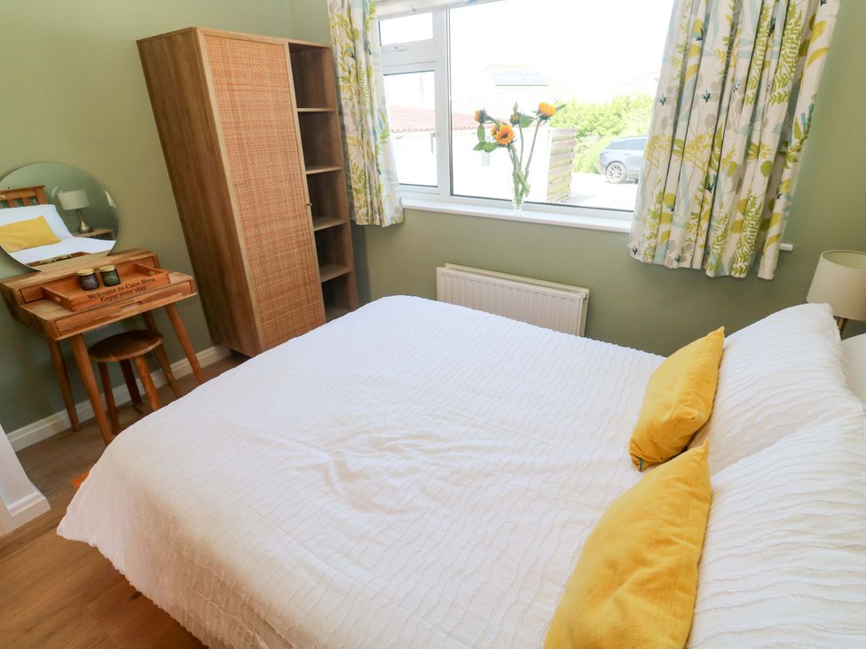 A bedroom with a bed and wardrobe at Carn Brea in Redruth