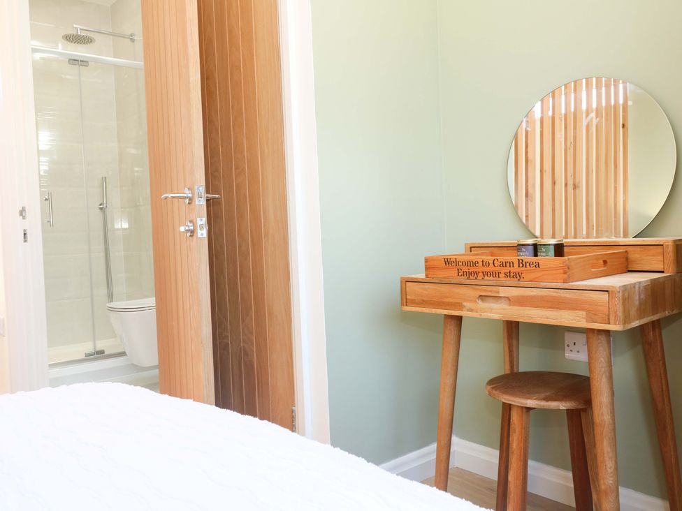 A bathroom with a shower and dressing table at Carn Brea in Redruth
