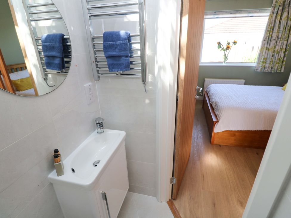 A bathroom with a sink and mirror at Carn Brea Redruth