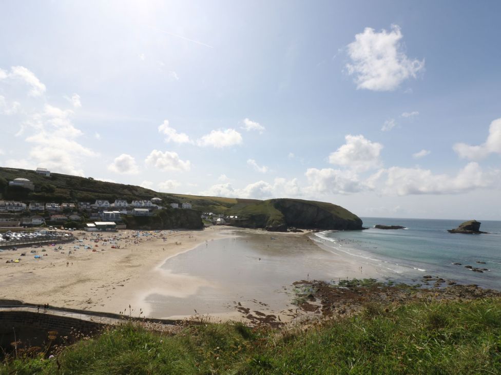 A beach scene with people and buildings in the background at Carn Brea Redruth