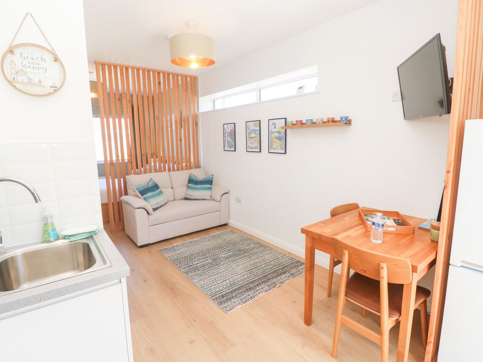 A living room with a sofa and dining table at Carn Brea Redruth