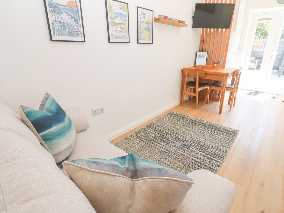 A living room with a sofa and dining area at Carn Brea in Redruth