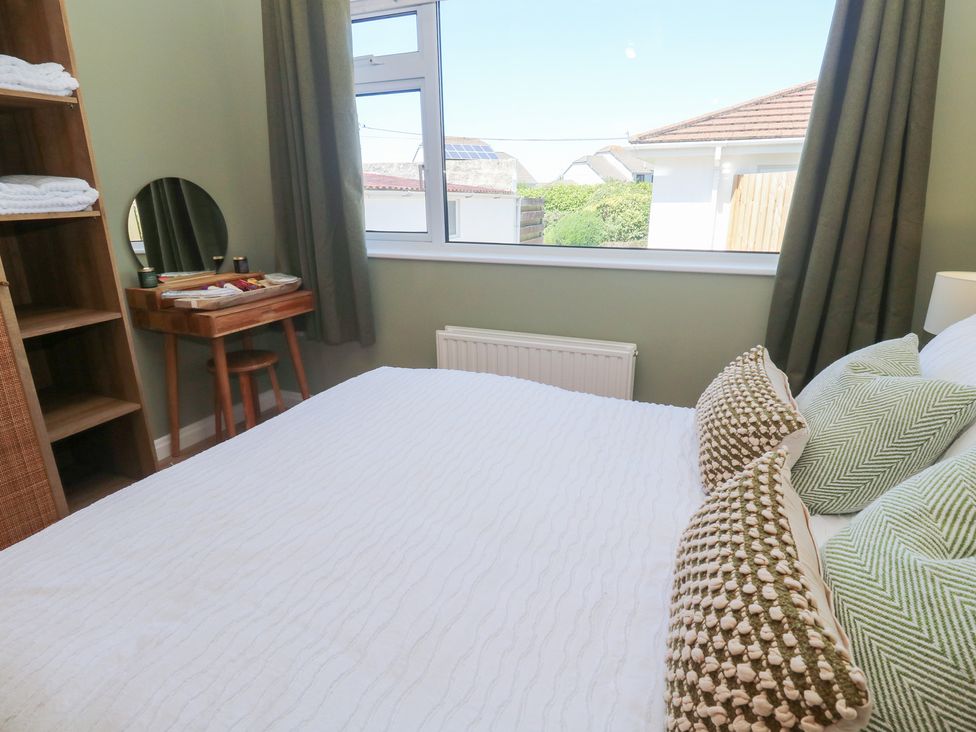 A bedroom with a bed and a table at Carn Brea in Redruth