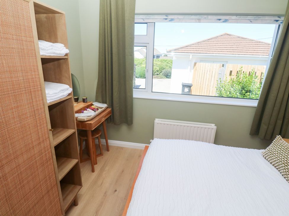 A bedroom with a bed and shelf at Carn Brea in Redruth